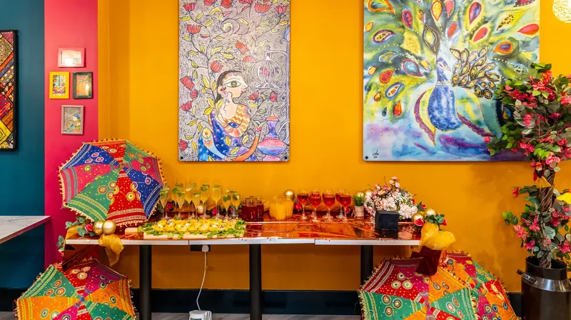 Decorated tables against the orange feature wall with framed truck art